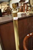A modern brass standard lamp of column form