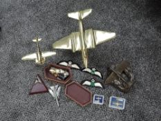 A box of Raf Badges, Sweetheart Broaches and Cloth Badges along with two brass model Aeroplanes,
