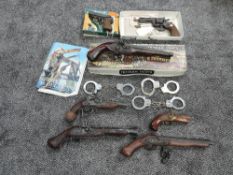 A collection of Relica Guns and Handcuffs including Flintlocks, Double Barrel Flintlock Pistol,