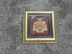 A 24th Foot Helmet Plate in display case