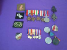 A collection of WW2 Medals and Badges including Kings Royal Rifle Badge, 6th & 8th Army Cloth
