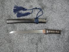 A Japanese Wakizashi with black lacquered scabbard, no marking to blade, grip has two ornate hilt