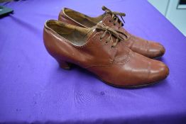 A pair of ladies 1940s tan coloured heeled lace up shoes, around a UK size 7.