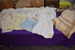 A selection of vintage and antique children's and baby clothing including quilted cape and