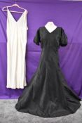 A stunning 1930s art deco bias cut black gown having wonderful slit details to puff sleeves and to