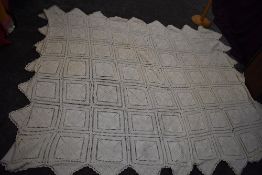 A vintage throw consisting of knitted panels with bobble like detailing.