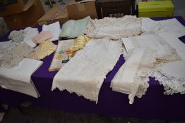 A collection of vintage and antique table linen amongst which are damask cloths and napkins, and