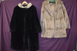 A 1960s Beaver lamb coat in black with silver mink collar, medium to larger size.