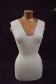 A wood and fibreglass cloth covered mannequin.