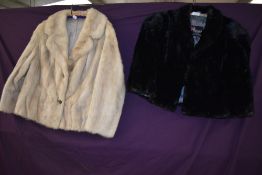 A vintage black moleskin cape and a blonde mink jacket.