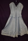 A 1940s full length evening dress having peplum waist and sequin and braiding to v necked bodice,