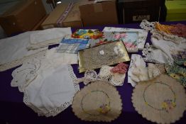 A selection of items including vintage boxed tea towel set, handmade lace dressing table set and a