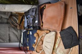A mixed lot of vintage handbags, varied colours and sizes, many with frames and clasp fastenings.