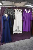 A selection of vintage 1960s maxi dresses including white Carnegie dress with swirled black piped