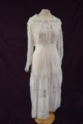 An early 20th century fine white cotton tea dress having panels of lace and pin tucks,large