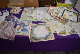 An array of vintage and antique handkerchiefs including many souvenir and novelty examples including