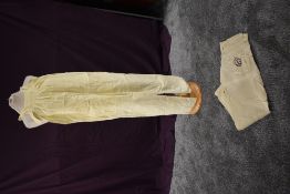 A pair of lemon yellow vintage cotton dungarees and a pair of Dolce and Gabbana jeans.