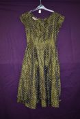 A vintage 1950s olive green taffeta Wendy dress having polka dot pattern,frilled hem and back