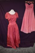 Two vintage 1950s evening gowns in bright pinks,halter neck needing new zip, small to medium sizes.