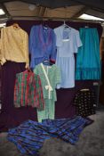 A selection of vintage and retro ladies clothing amongst which are dresses and blouses.