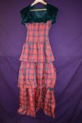 A vintage 1950s tartan evening gown with tiered skirt and matching bolero.
