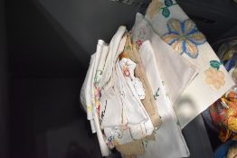 An assortment of embroidered table linen including tray cloth, table cloths and similar.