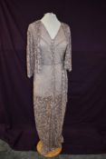 A 1930s full length lace art deco dress and matching jacket in pink and black.