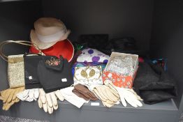 A mixed collection of vintage handbags, hats, gloves scarves and other accessories.