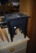 A 19th Century stained frame low plant stand having carved decoration