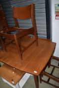 A vintage teak extending dining table and set of four chair frames (seats removed)