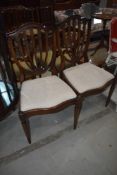 A pair of reproduction Regency feather back dining chairs
