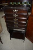 A late 19th or early 20th Century mahogany music cabinet