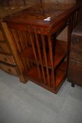 A reproduction inlaid revolving bookcase
