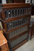 A late 19th or early 20th Century four tier oak stacking bookcase, having leaded glass fronts,