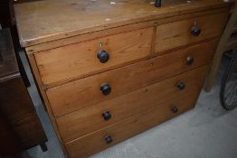 A stripped pine chest of two over three drawers, width approx. 114cm