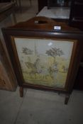 An early 20th Century oak fire screen having tapestry inset, Arabian theme