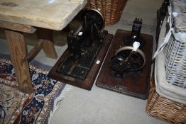 Two traditional hand crank sewing machines