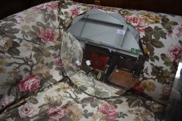 A vintage frameless wall mirror