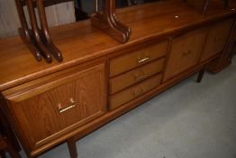 A vintage teak sideboard , width approx 200cm, with brassed handles to double and single cupboard