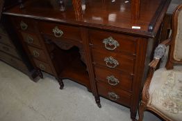 A Victorian mahogany sideboard having ledgeback and recessed centre section, turned legs and pot