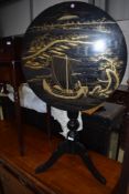 A 19th Century ebonised snap top table , the circular top having Japanesque raised laquerwork