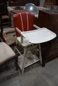 A vintage Childs folding high/low chair , wooden frame and vinyl seat