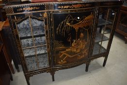 A 19th Century ebonised and japanesque display cabinet having central bow fronted cupboard