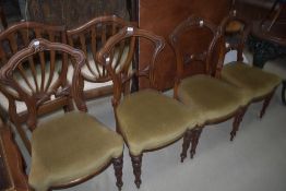 A set of four Victorian dining chairs having Gothic style rail backs and classical style legs