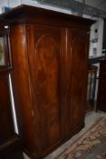 A Victorian mahogany wardrobe having panelled doors