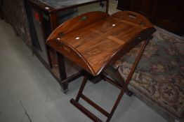 A traditional hardwood butlers tray and stand