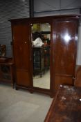 An Edwardian mahogany and inlaid mirror door wardrobe, width approx. 173cm