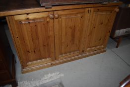 A pine and tile top counter, with triple cupboard, width approx 135cm