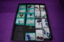 Nineteen pairs of fashion loop drop earrings of various forms including glass, mineral, hematite