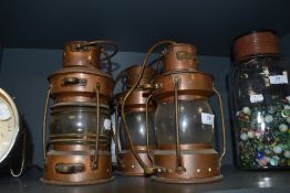 Three vintage ships or ships style lamps converted to lamps, each having a badge to top reading '